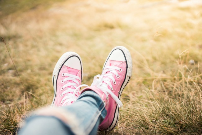 girl-with-pink-shoes-laying-in-meadow-picjumbo-com