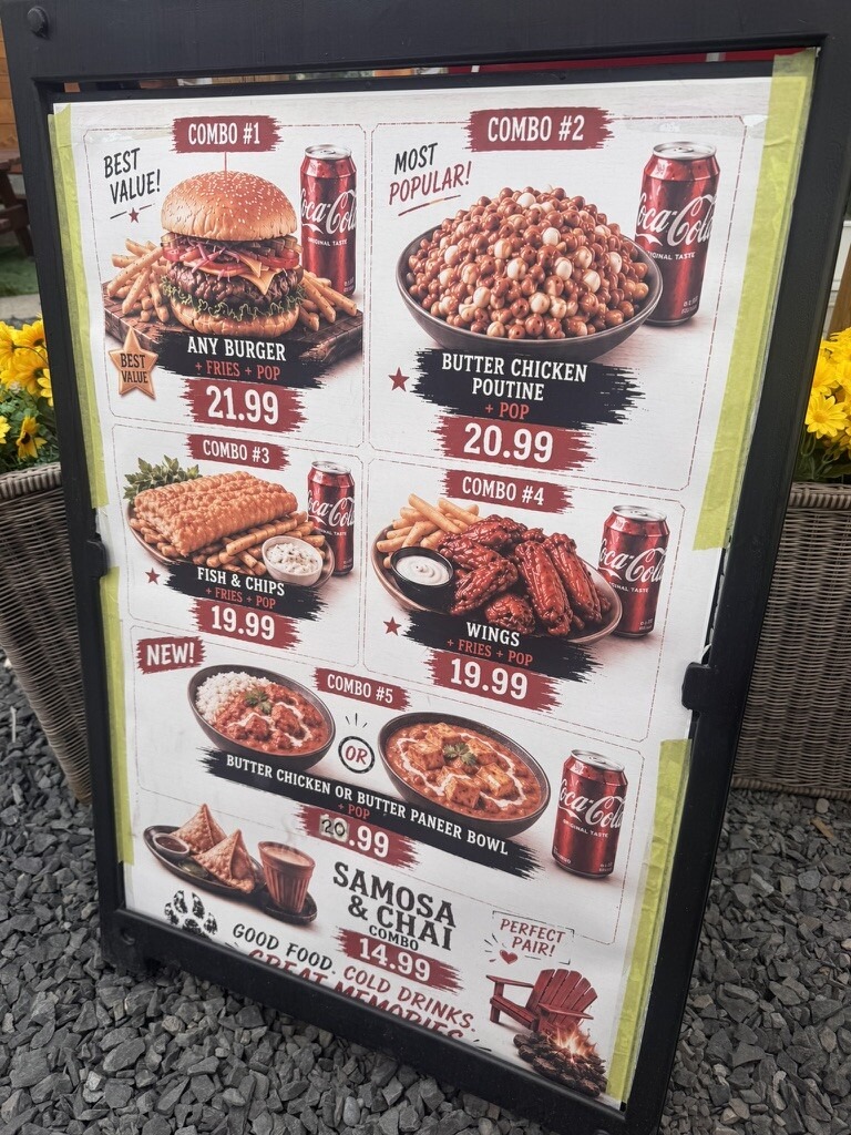 Chip truck sandwich board menu with AI-generated food images of a burger, butter chicken poutine, fish and chips, wings, and curry bowls
